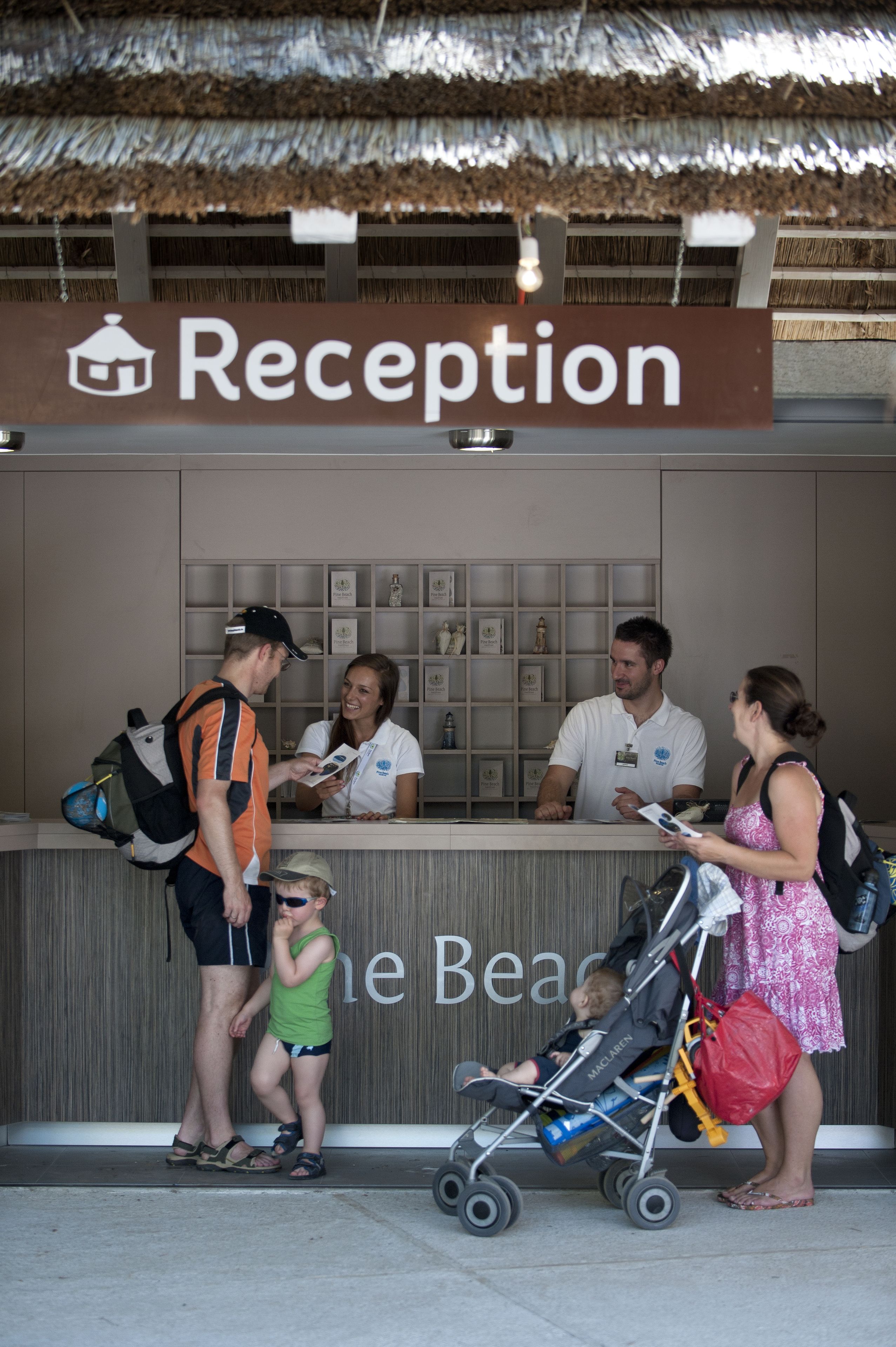 A reception area with a sign labeled "Reception" and a counter.