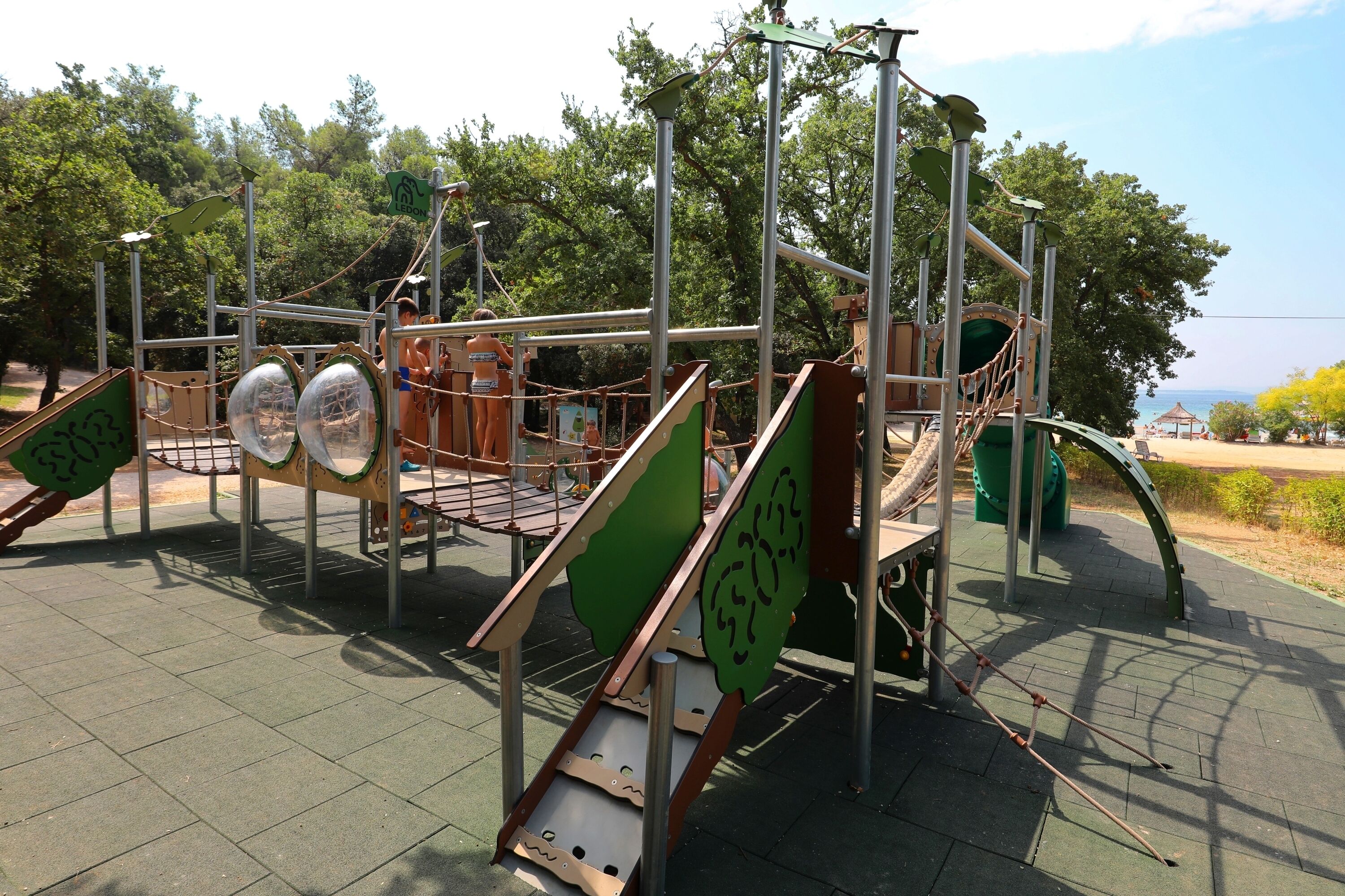 A playground with various climbing structures and slides.