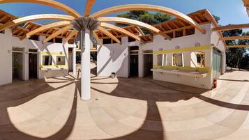 Experience the unique, open design of this architectural structure, featuring a central column and multiple doorways.