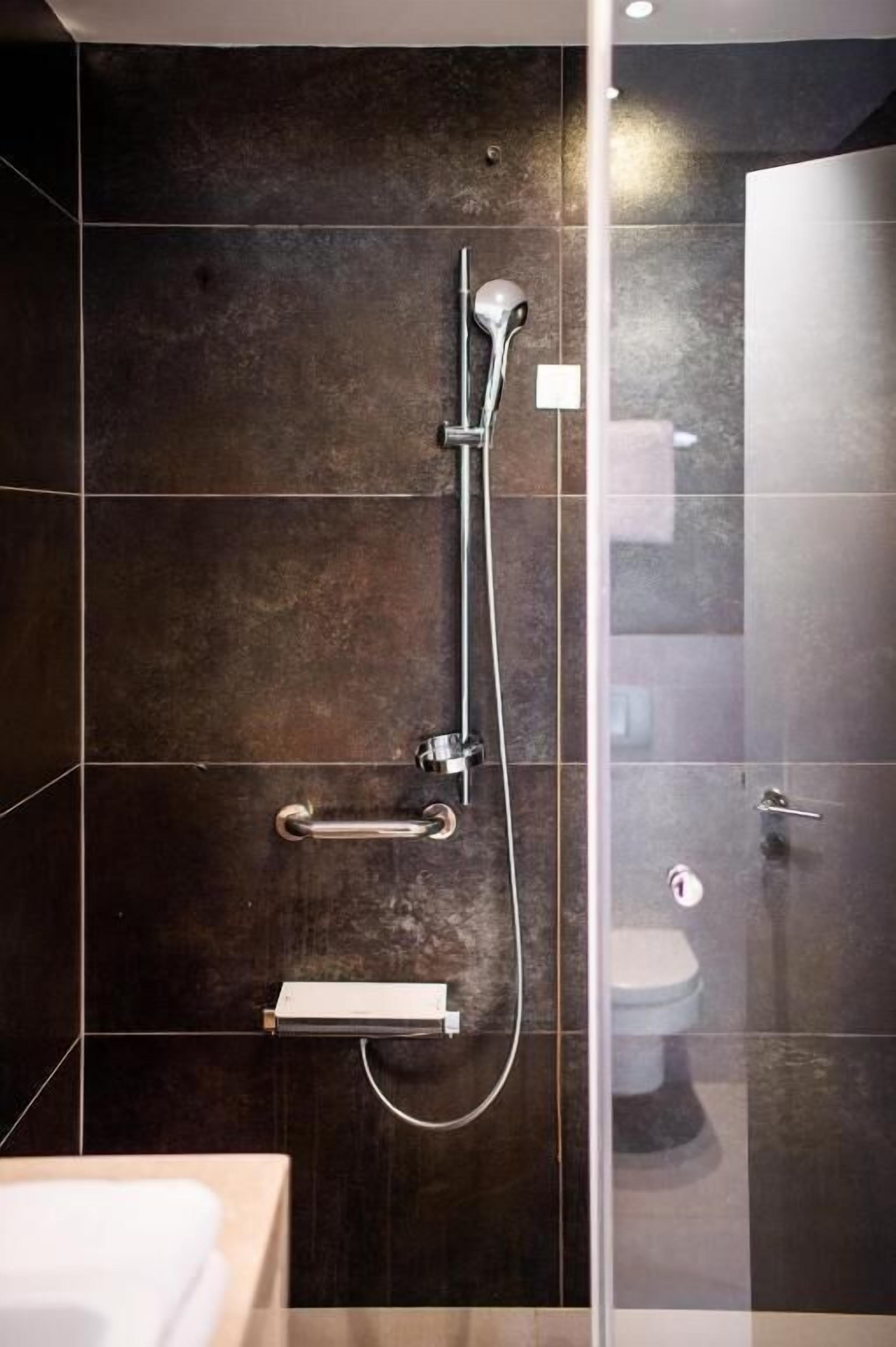 designer toiletries, hair dryer, slippers, towels