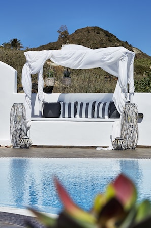 Relax by the serene pool surrounded by a tranquil hillside setting.