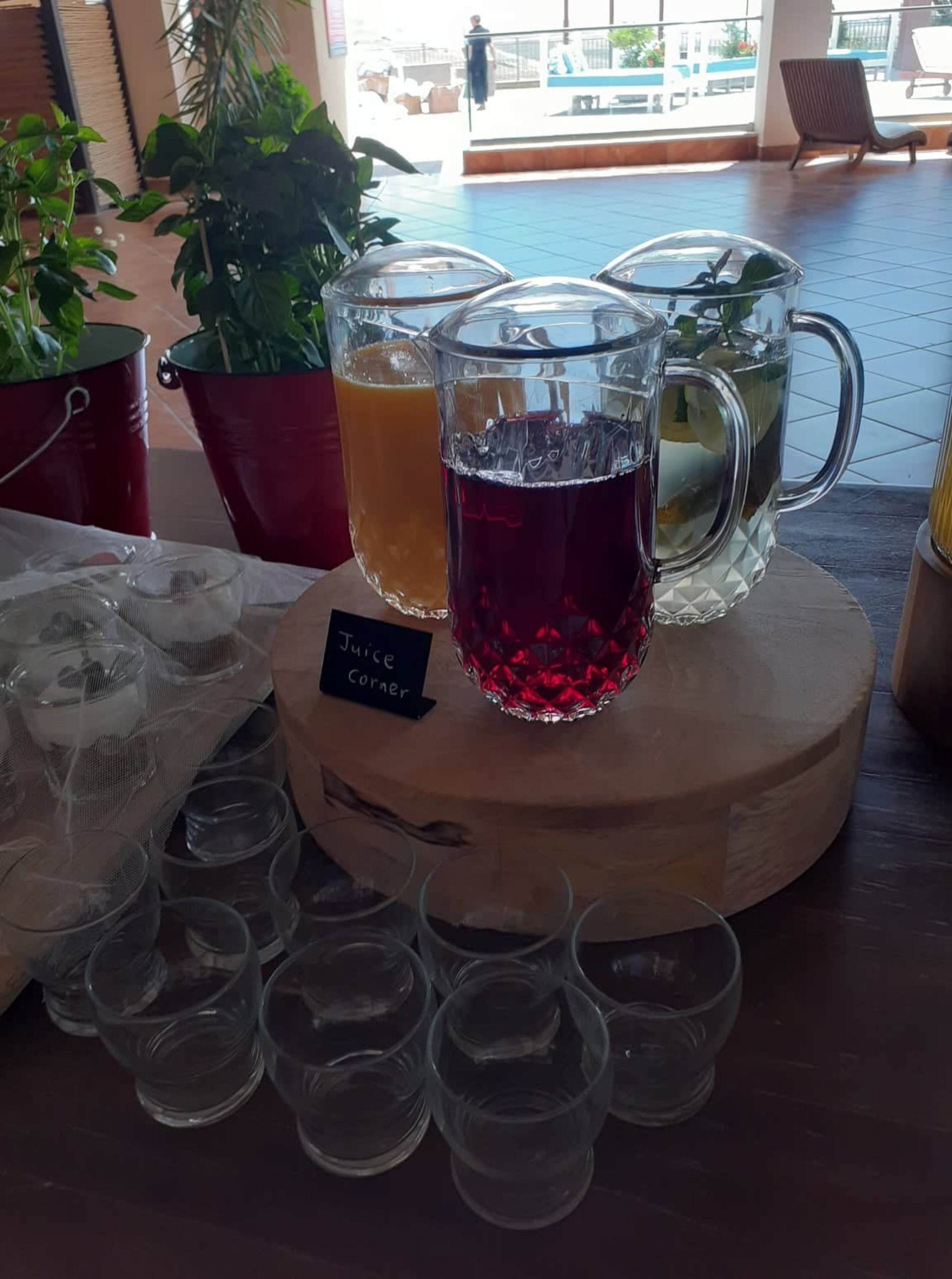 A juice bar with various drinks and a sign indicating 'Juice Corner'.