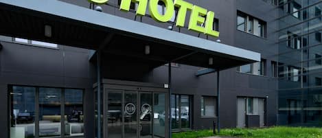 A modern hotel building with a prominent sign reading "HOTEL".