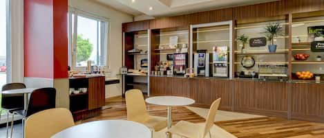A modern cafe with wooden paneling, a coffee machine, and a fruit display.