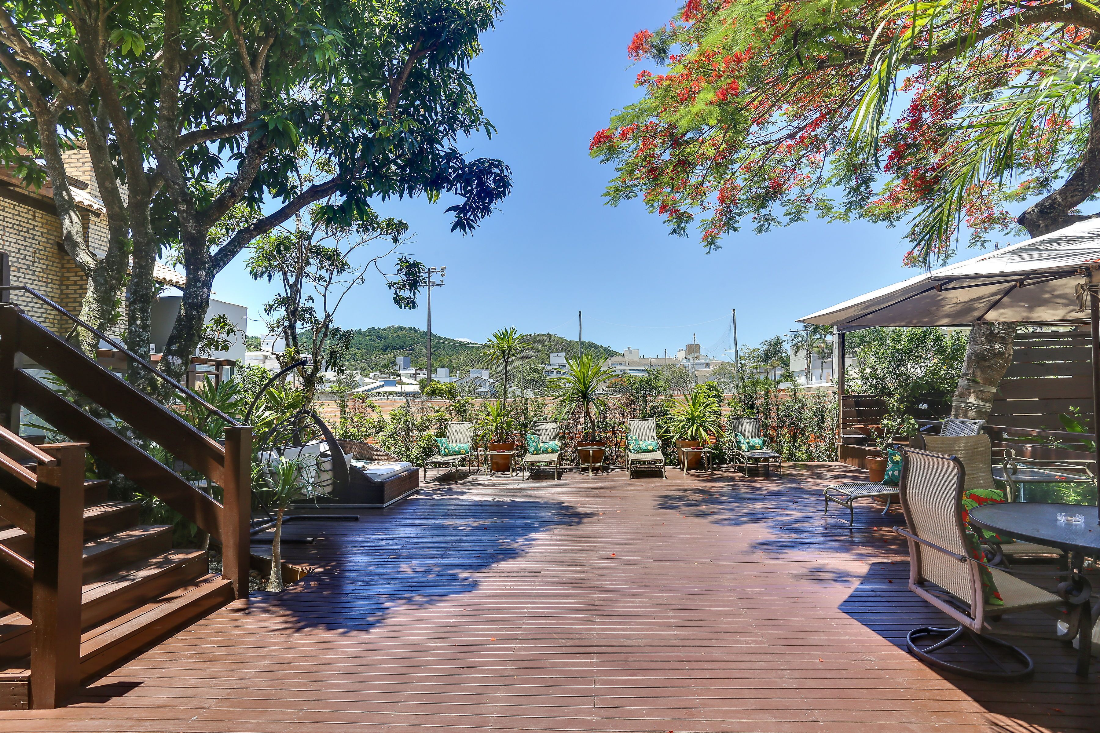 A wooden deck with outdoor seating and a staircase.