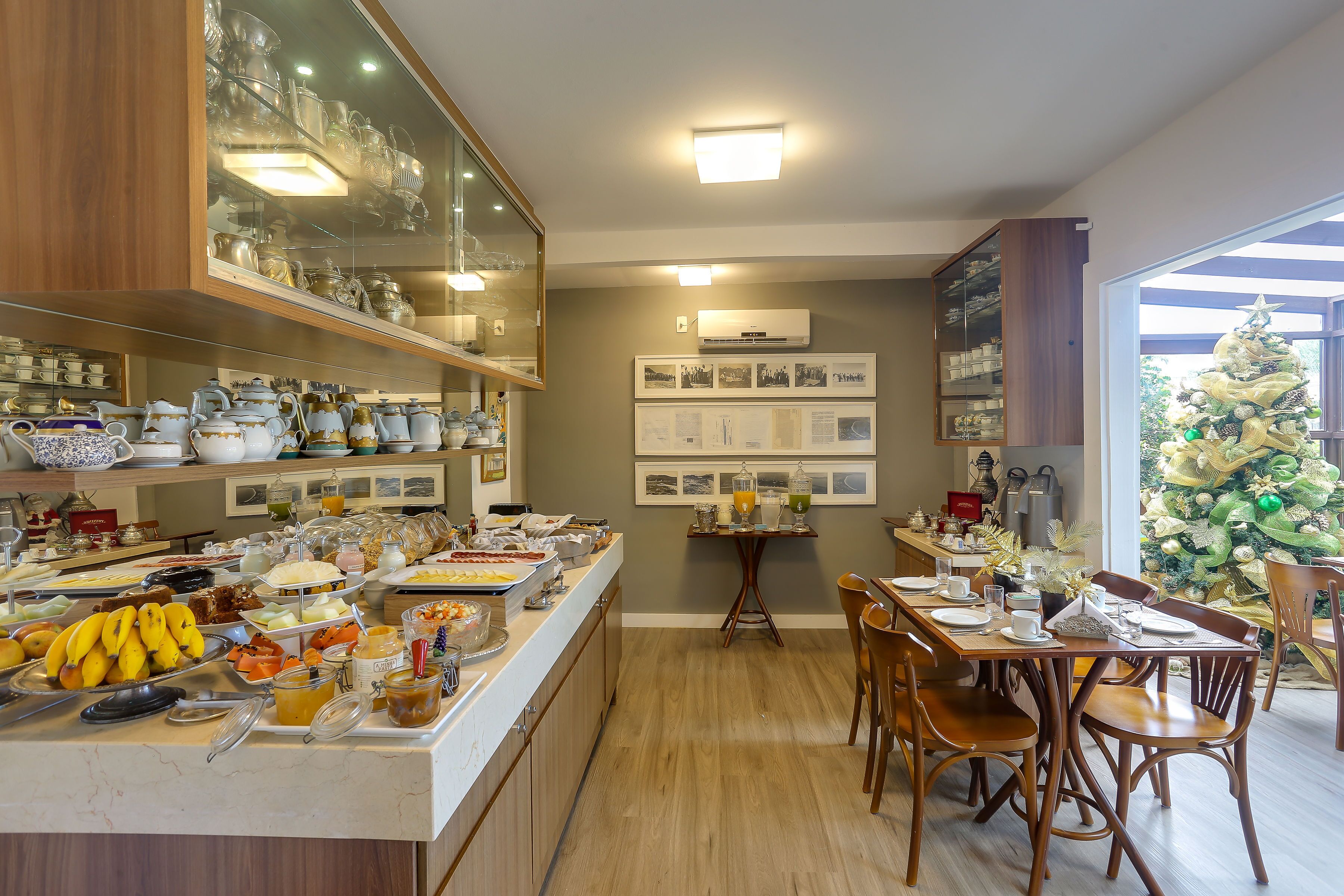 A breakfast buffet with various food items and a Christmas tree in the background.