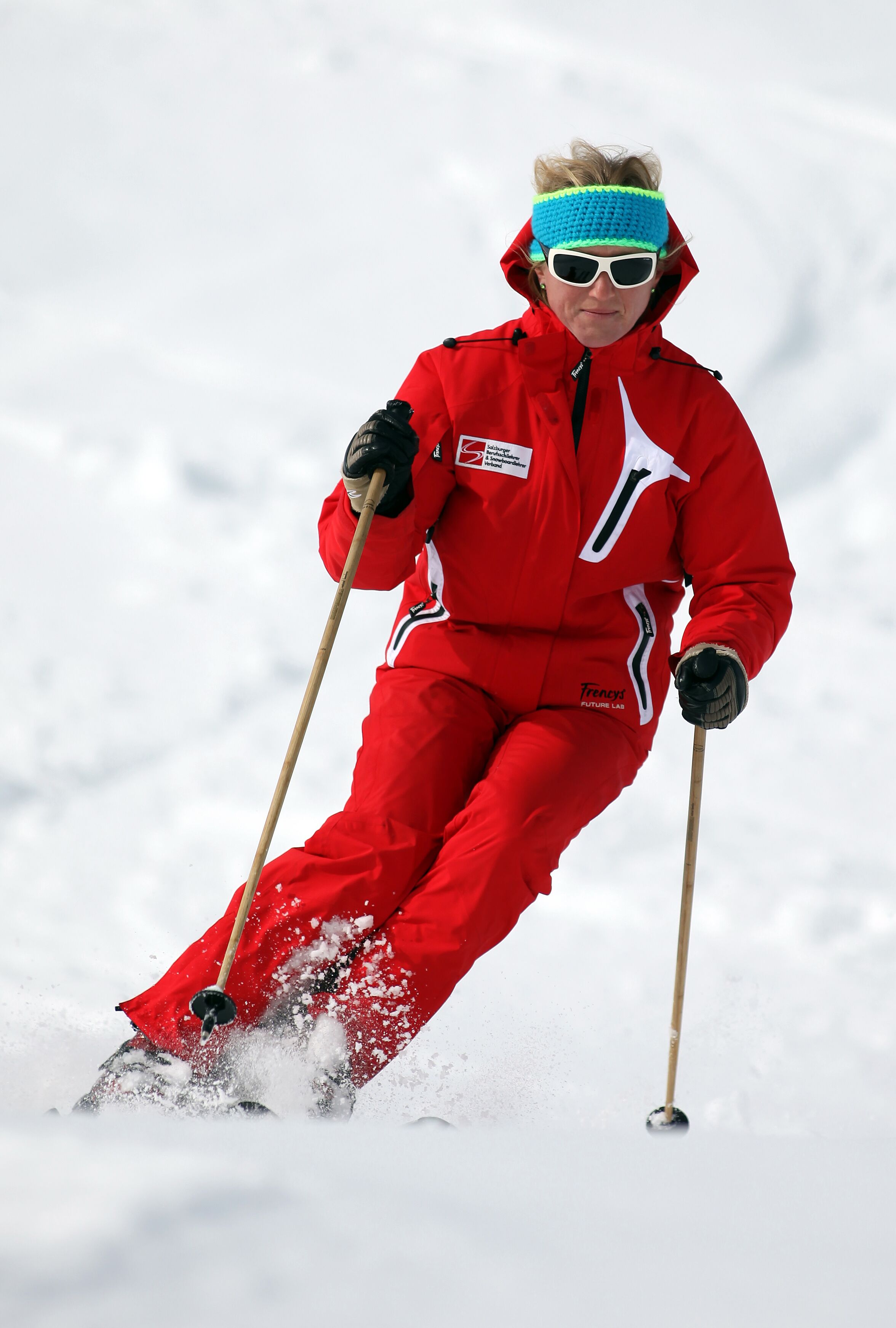 Una persona esquiando con un traje de nieve rojo.