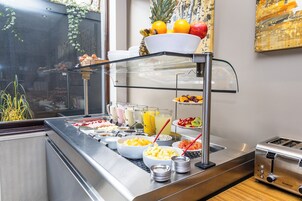 A breakfast buffet with various food items and beverages.