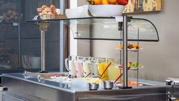 A buffet setup with various food items and beverages.