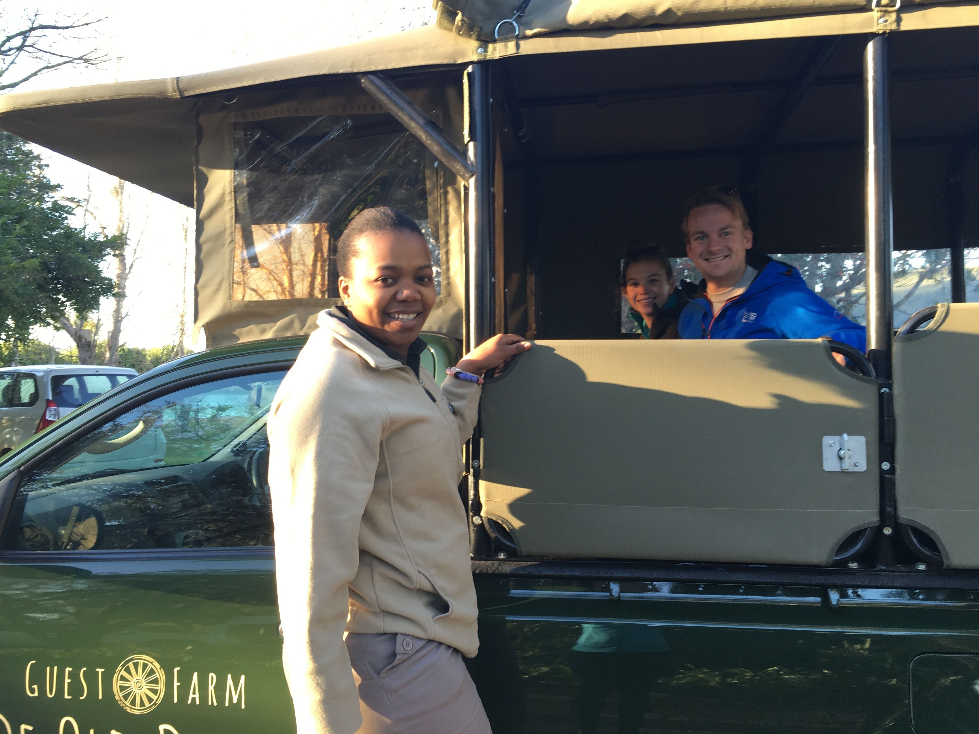 A vehicle with a covered top and a logo that reads "Guest Farm."