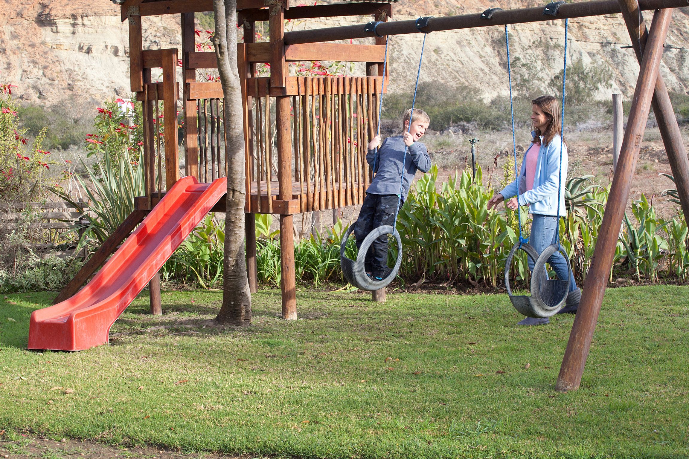 A playground with a slide and swings.
