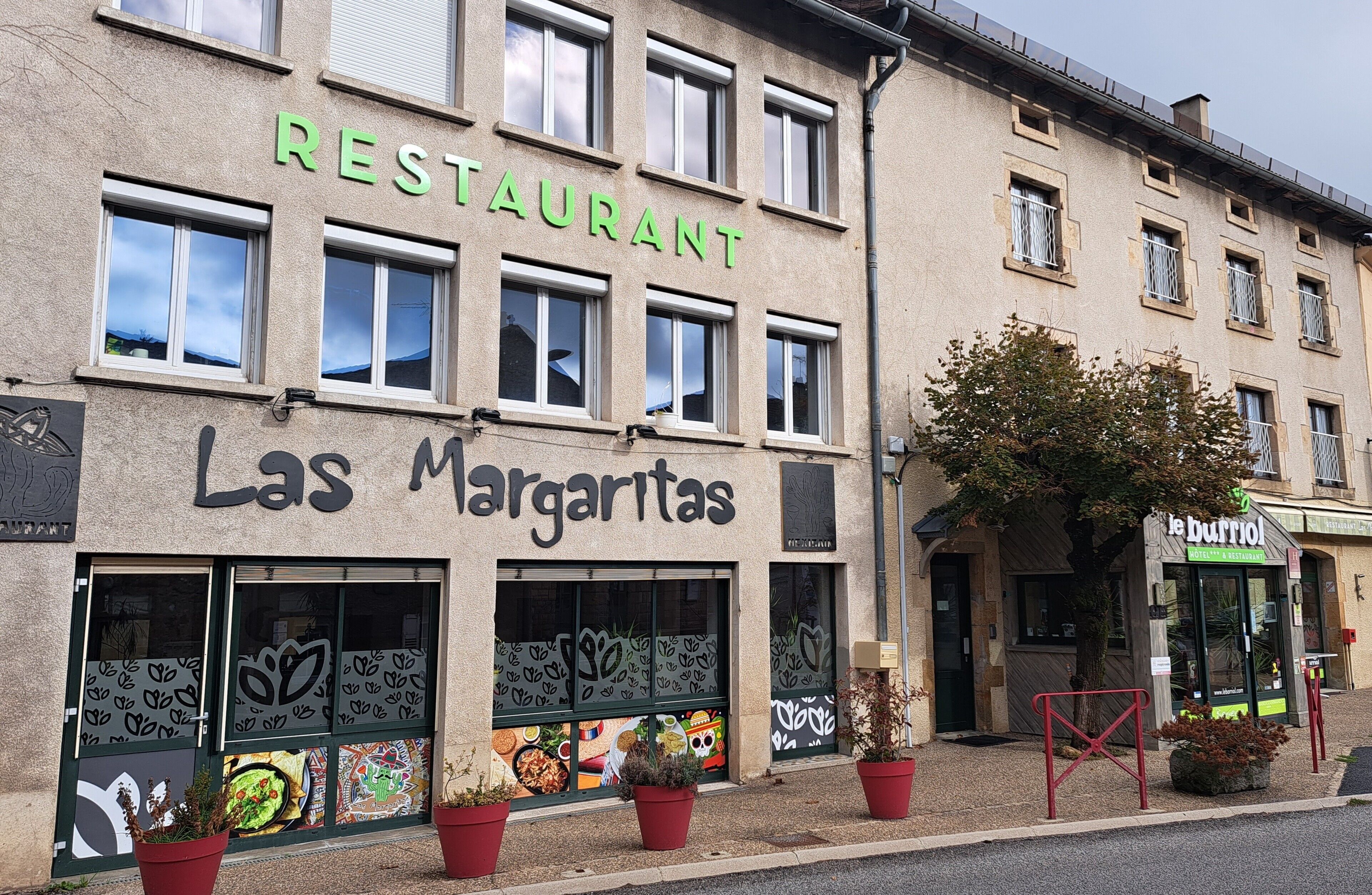 A building with a sign that reads 'RESTAURANT' and 'Las Margaritas.'