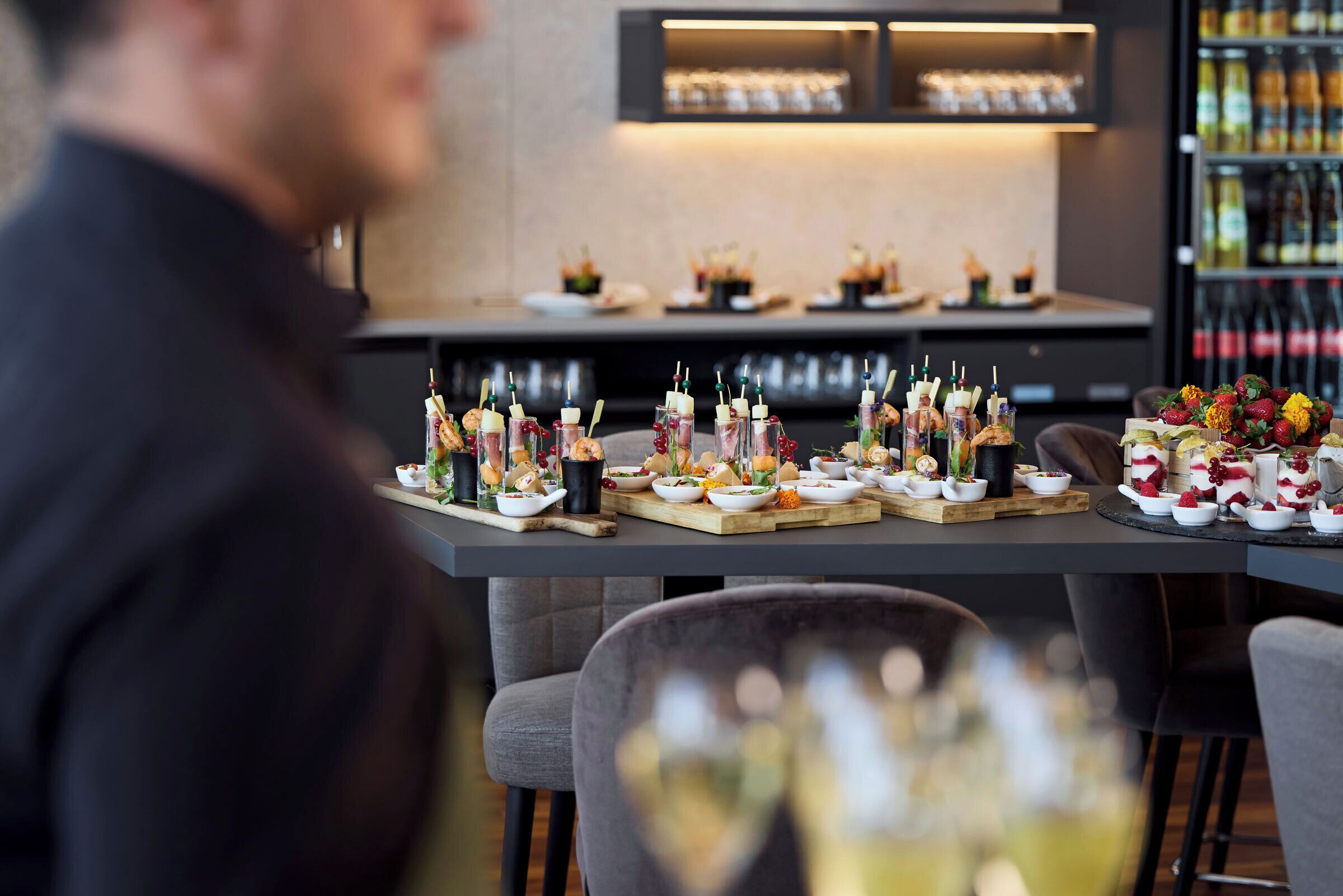 Een eettafel met diverse gerechten en drankjes, waaronder spiezen en glazen wijn.