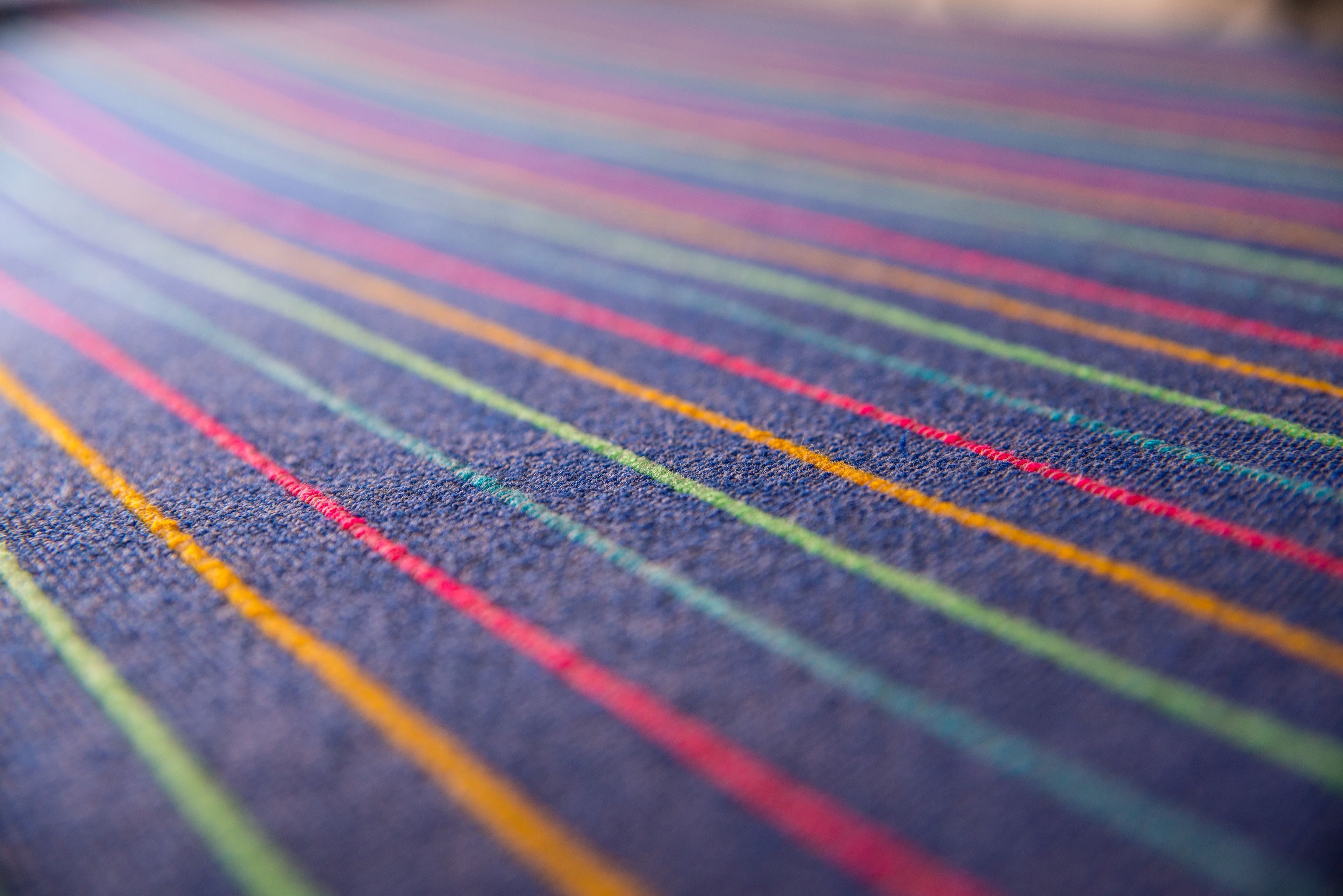 A close-up of a fabric with horizontal stripes in various colors.