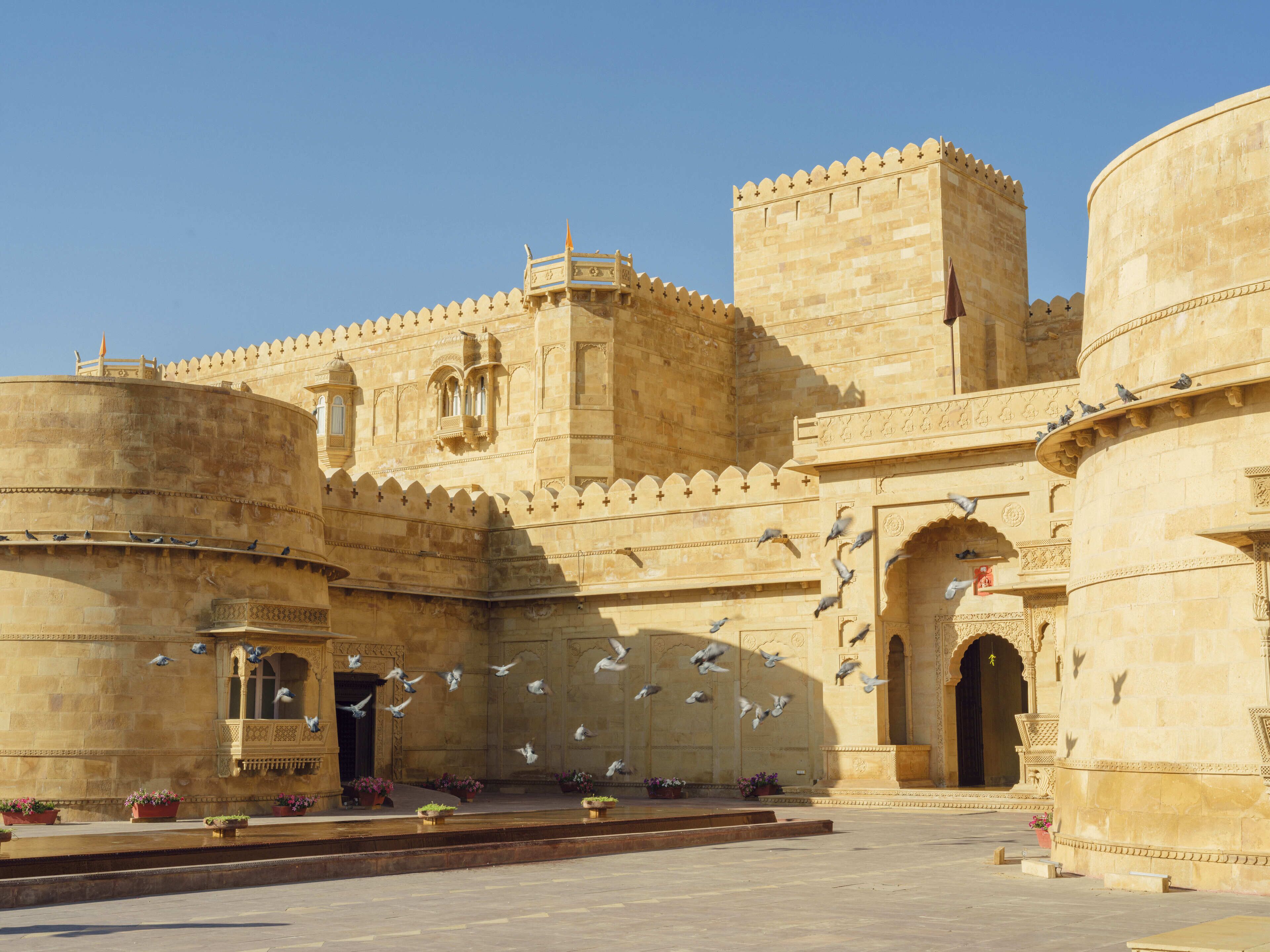 A historic building with intricate architecture, including arched doorways and decorative stonework.