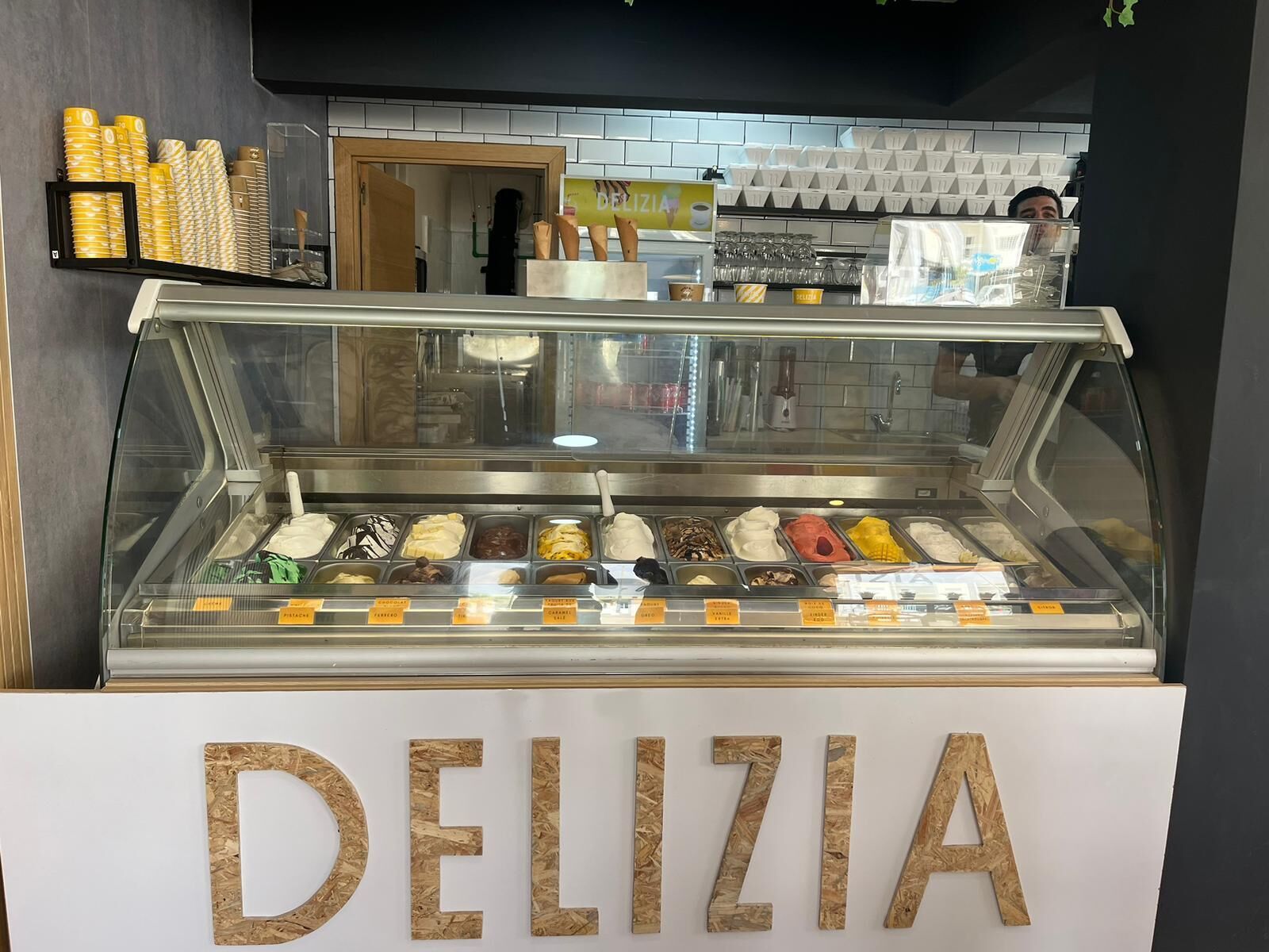 A deli counter with a variety of food items displayed in a glass case.