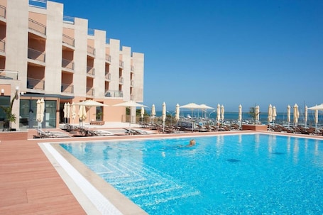 Outdoor pool, pool umbrellas, sun loungers. Real Marina Hotel & Spa