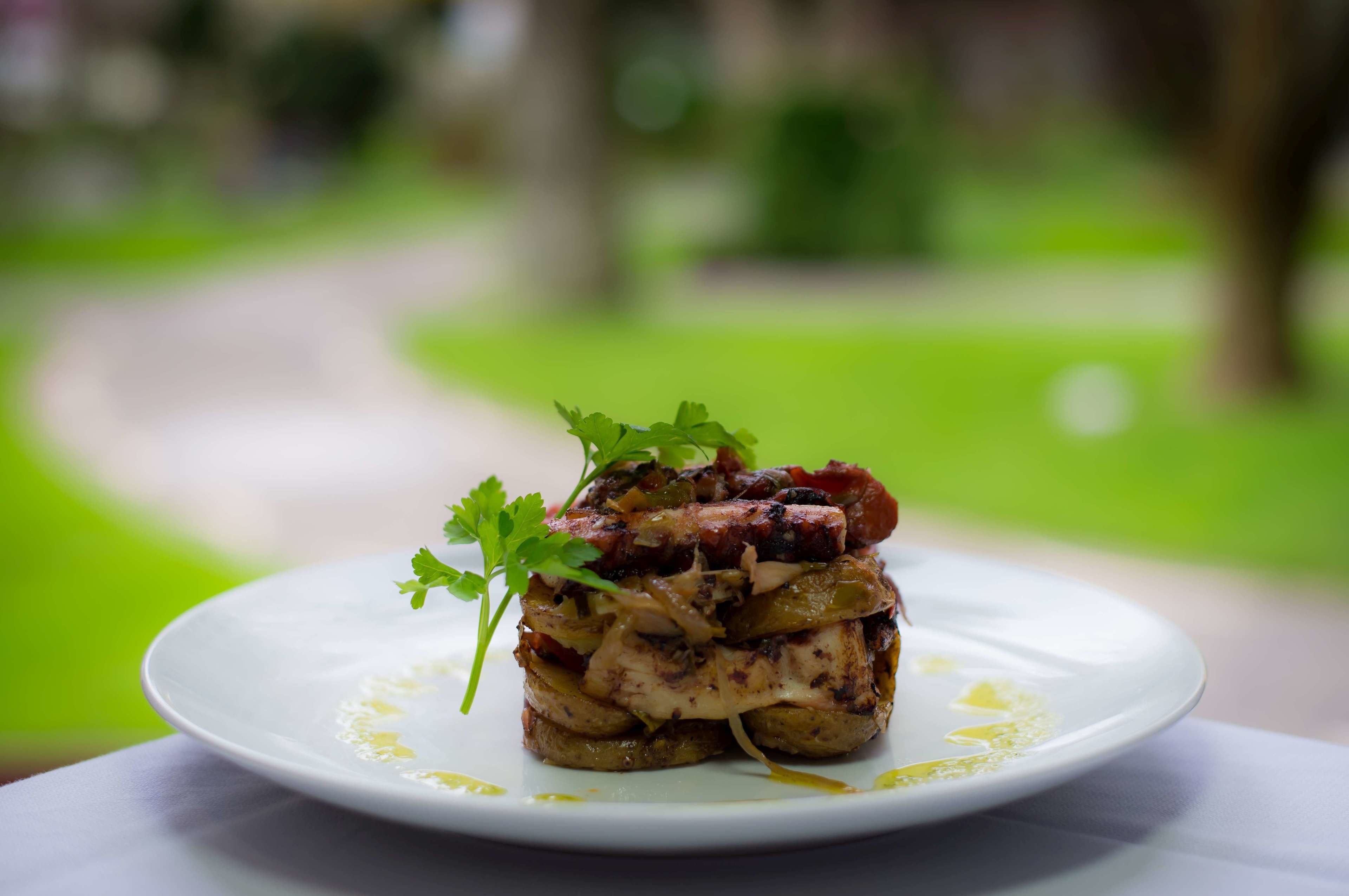 A plate of food with a garnish on a white plate.