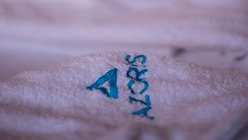 A close-up of a textured surface with a blue embroidered symbol.