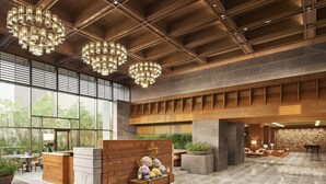 A spacious lobby with a wooden reception desk, large windows, and a seating area with a piano. - Taj City Centre New Town Kolkata (Barasat)