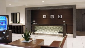 A modern lobby with a reception desk, seating area, and a vending machine. - Hotel Vista Ebina (Ebina)