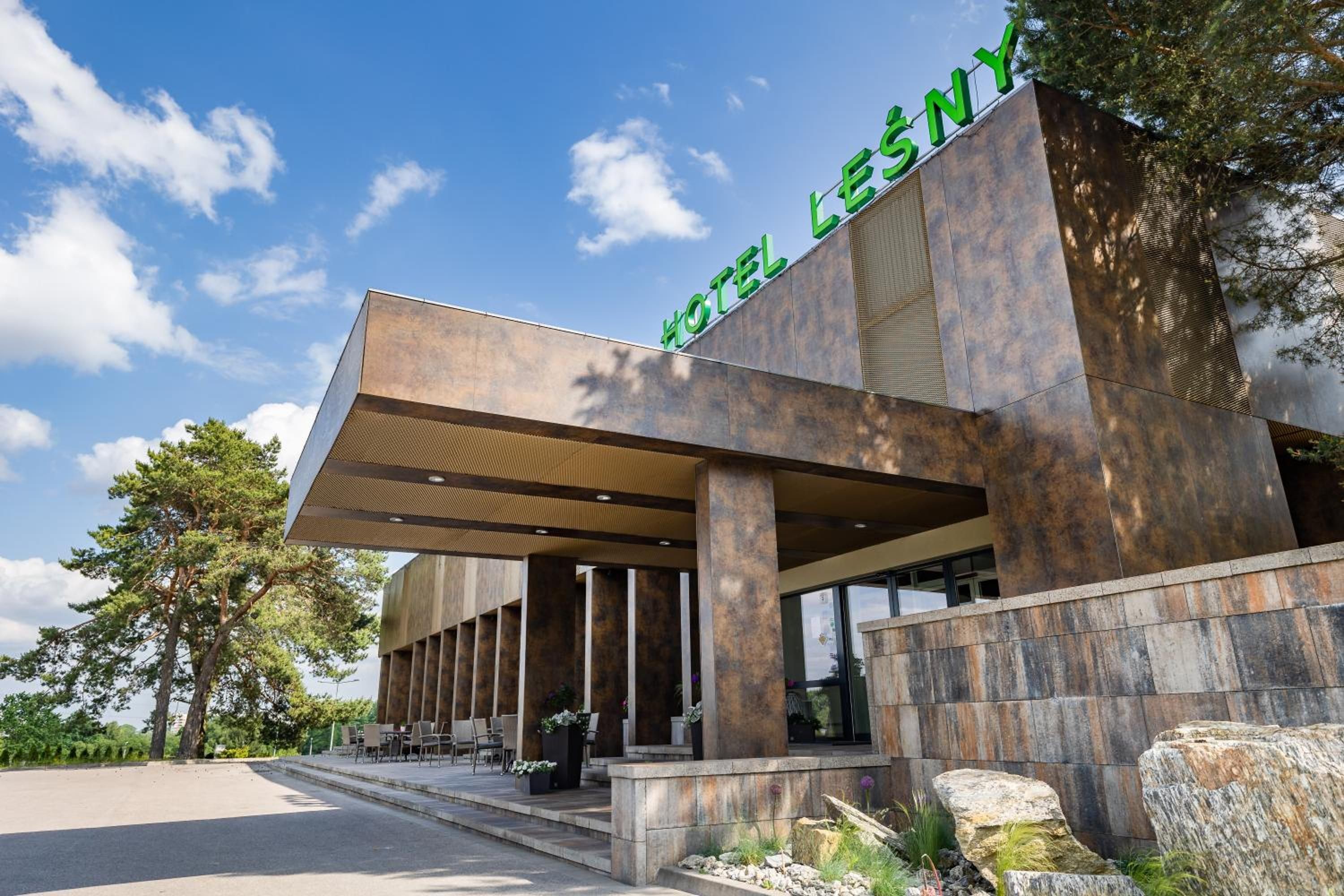A modern hotel with a prominent sign reading 'HOTEL LESNY'.
