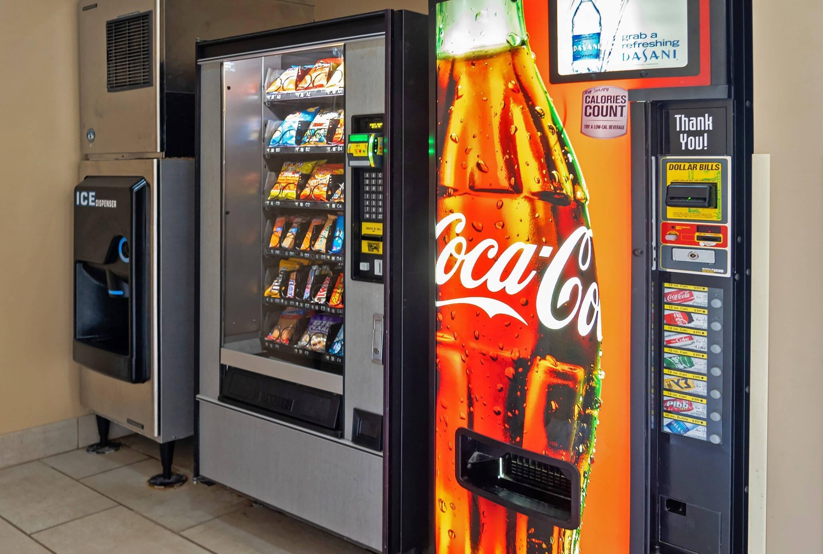 A vending machine with a Coca-Cola logo and a cash dispenser.