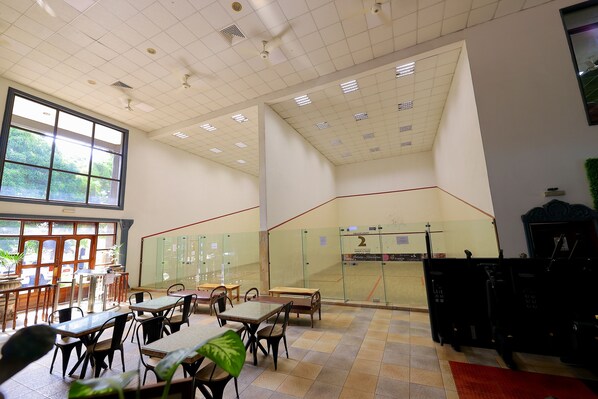 A spacious indoor area with high ceilings, large windows, and multiple seating arrangements.