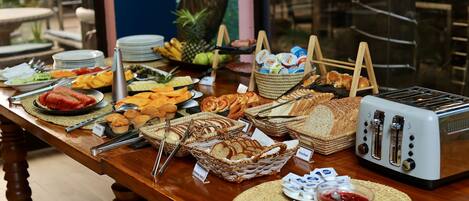 A buffet table with various food items and a toaster.