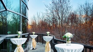 A balcony with tables set for an event, overlooking a forested area. - Homewood Suites by Hilton Rockville-Gaithersburg (Rockville)