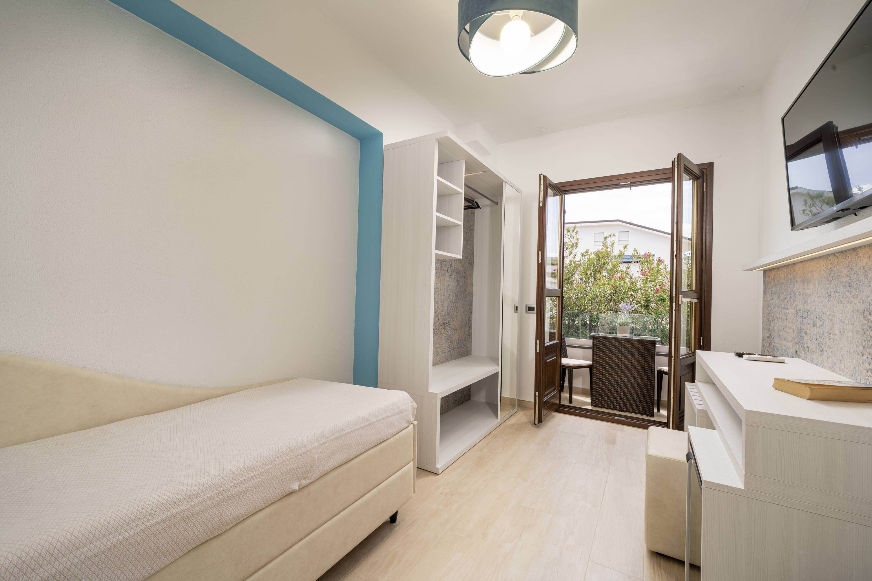 comfort room, 2 bedrooms, balcony, partial sea view | minibar, individually decorated, individually furnished, desk