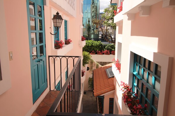 A narrow alleyway with a staircase, a blue door, and a lantern. - Vieja Cuba Hotel (Quito)