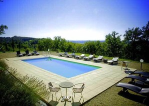 Seasonal outdoor pool, open 9:30 AM to 8:00 PM, pool loungers