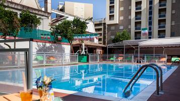 Seasonal outdoor pool, pool umbrellas, pool loungers