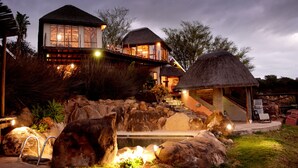 A resort with multiple buildings, a pool, and a thatched-roof structure. - Addo Dung Beetle Guest Farm (Addo)