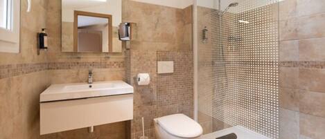 A bathroom with a sink, toilet, and shower.