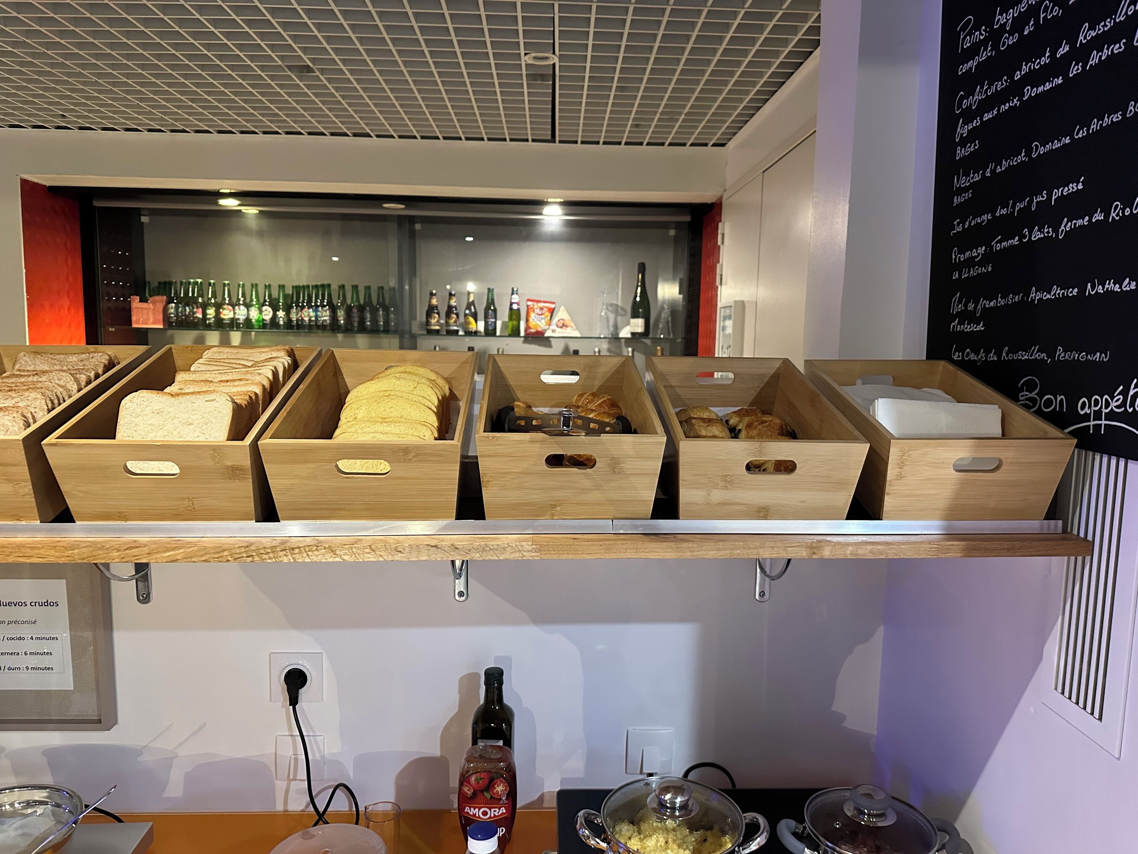 A bakery display with various breads and pastries.