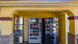 A vending machine area with a Pepsi dispenser and a water cooler. - OYO Hotel LSU (Port Allen)