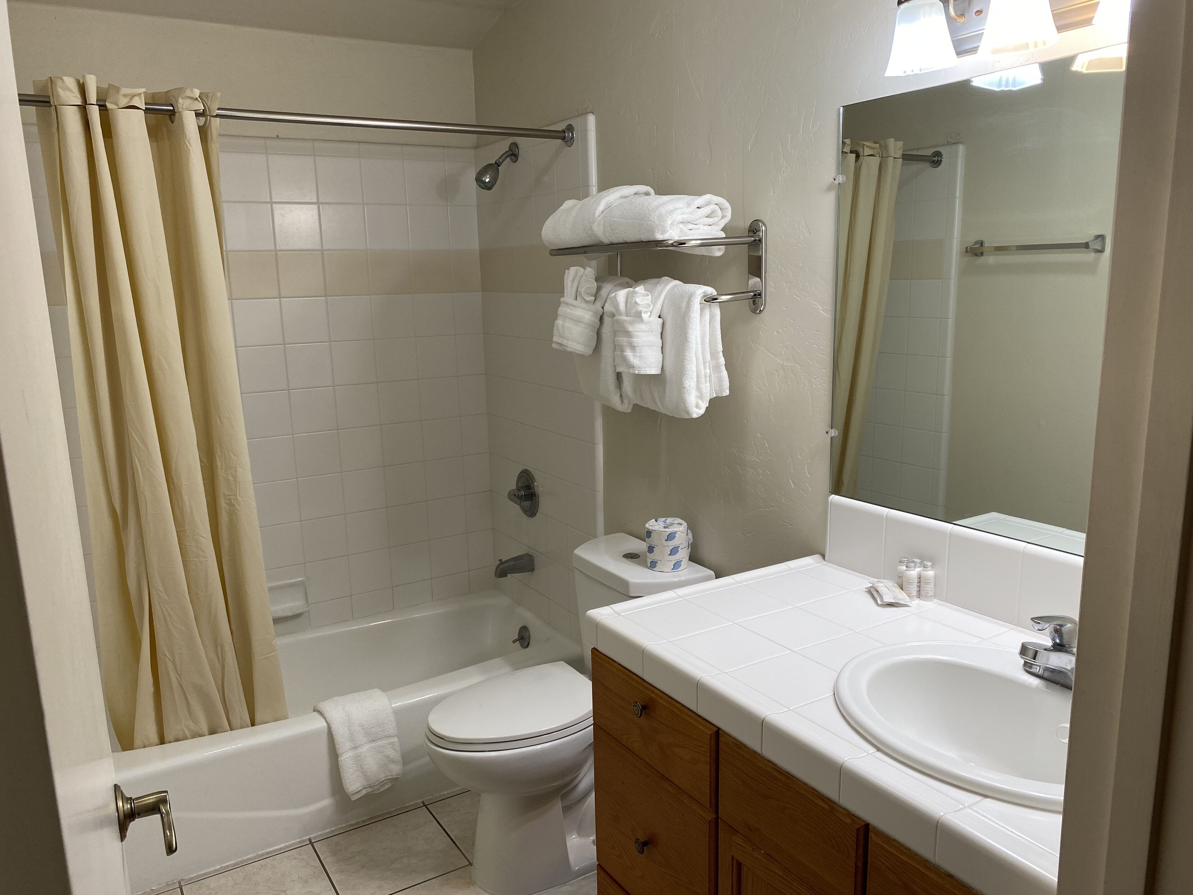 A bathroom with a bathtub, toilet, and sink.