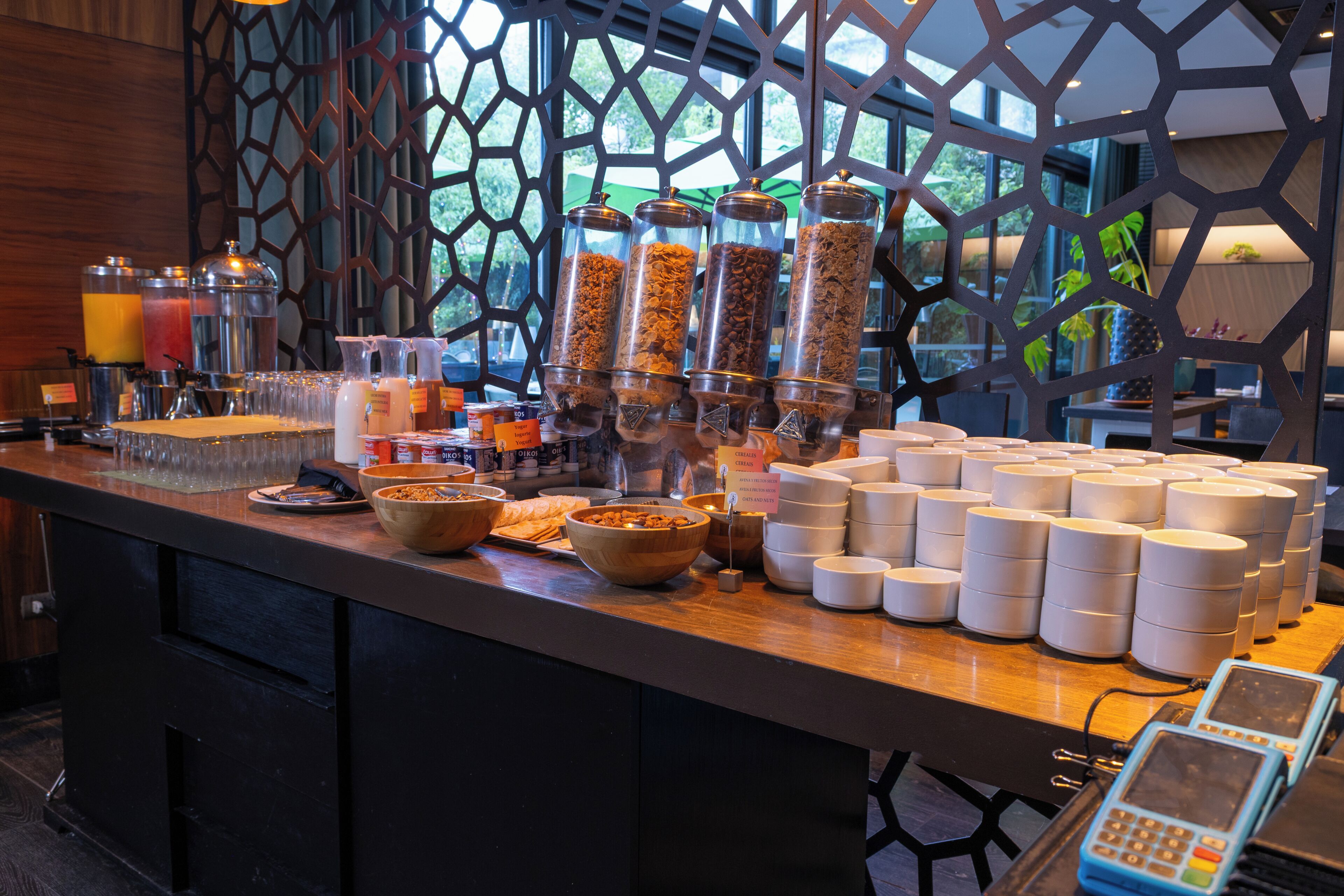 A breakfast buffet with various food items and a cash register.