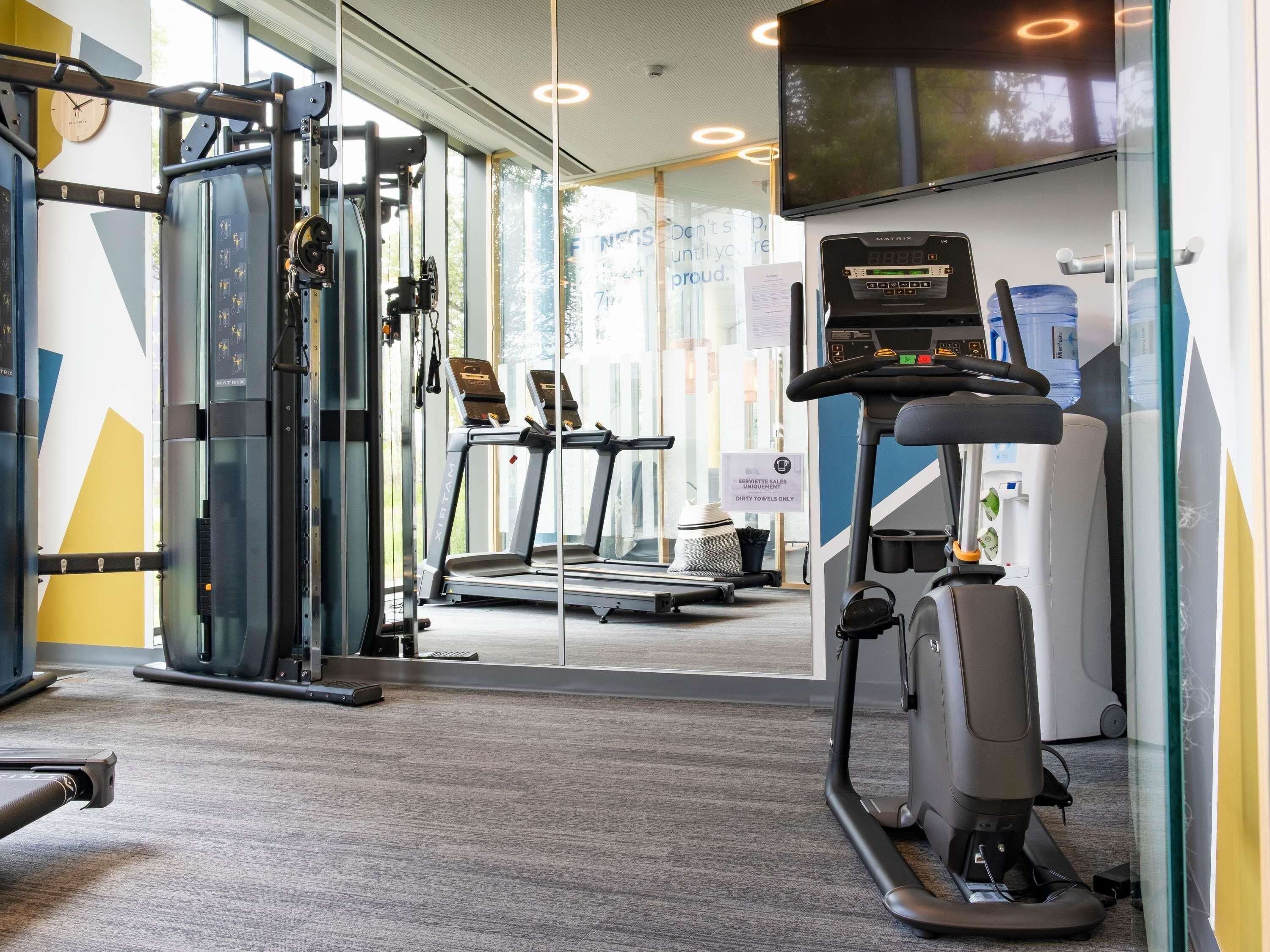 A gym with treadmills, a stationary bike, and weight machines.
