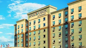 A multi-story hotel with a prominent sign reading "FOUR POINTS BY SHERATON". - Four Points by Sheraton Calgary Airport (Calgary)