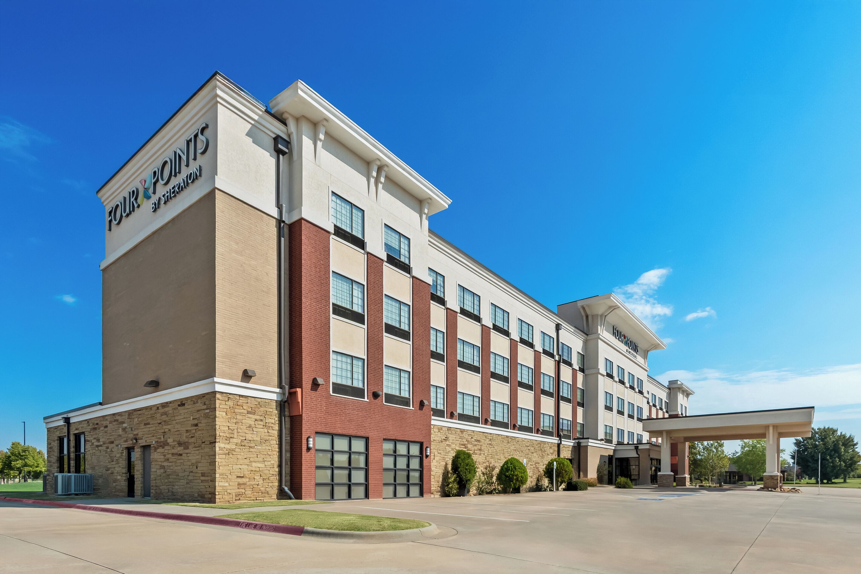 A multi-story hotel with a prominent sign reading "Four Points by Sheraton."