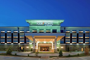 A hotel with a modern facade, a prominent entrance, and a parking area in front. - Four Points by Sheraton Oklahoma City Quail Springs (Oklahoma City)