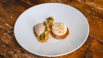 Un plato blanco con dos postres sobre una mesa de madera.