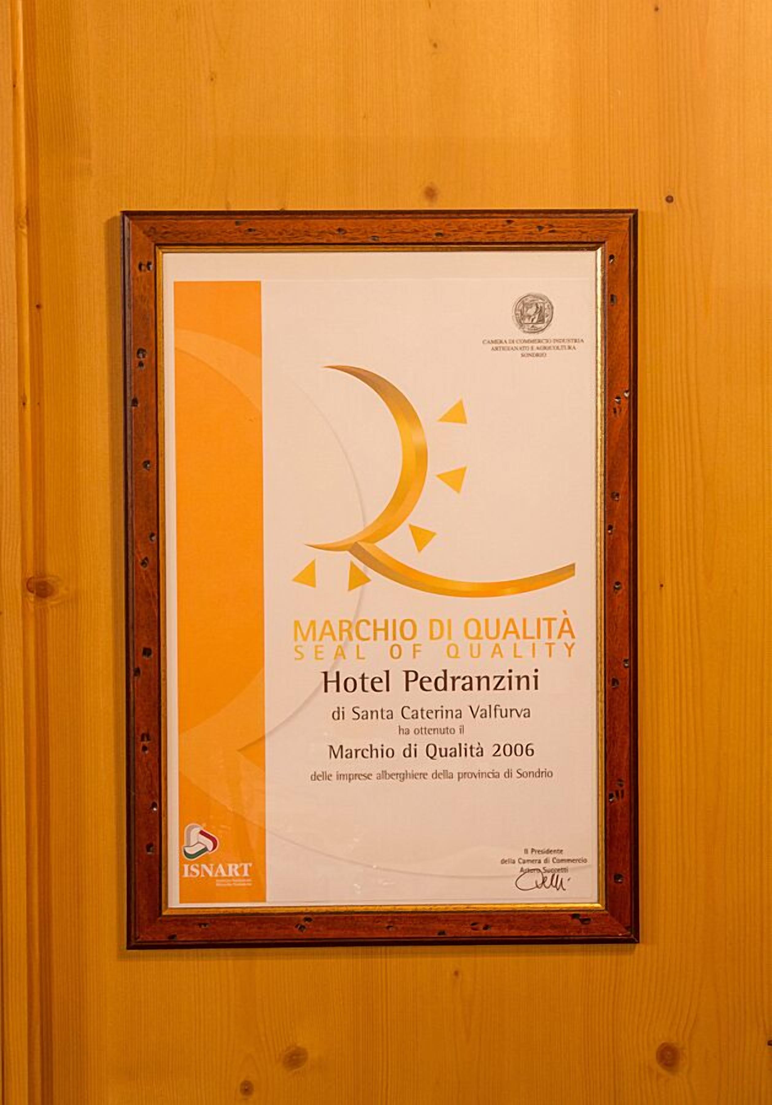 A framed award certificate for Hotel Pedranzini, indicating it received the Marchio di Qualità 2006 award.