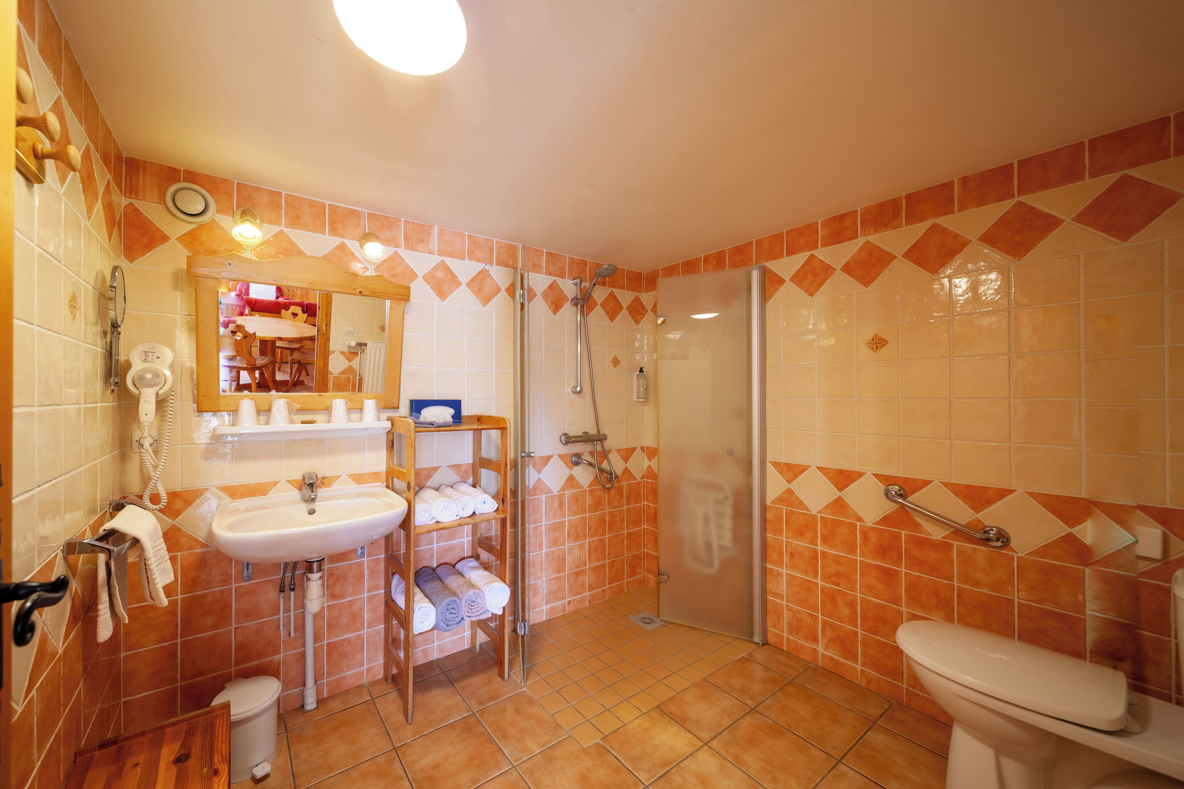 A bathroom with a sink, toilet, and shower.