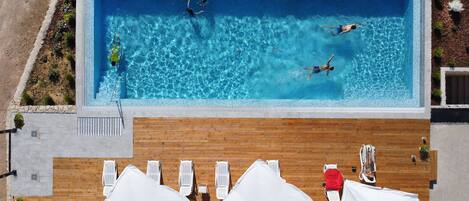 Seasonal outdoor pool, open 9:00 AM to 9:00 PM, pool umbrellas