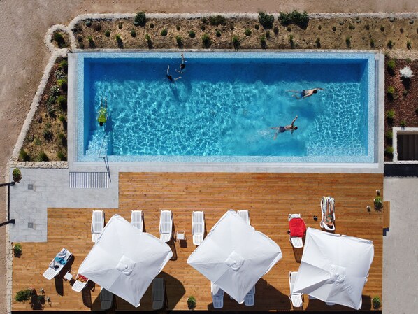 Seasonal outdoor pool, open 9:00 AM to 9:00 PM, pool umbrellas