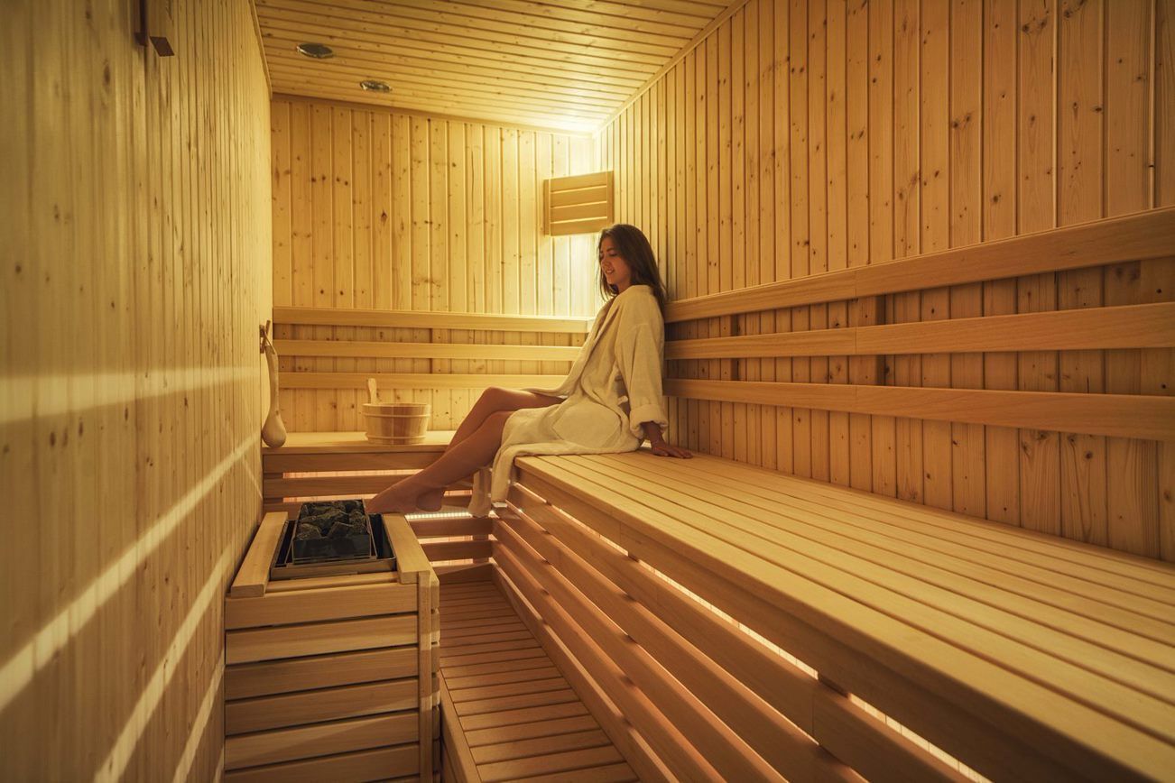 A wooden sauna with benches and a bench seat.